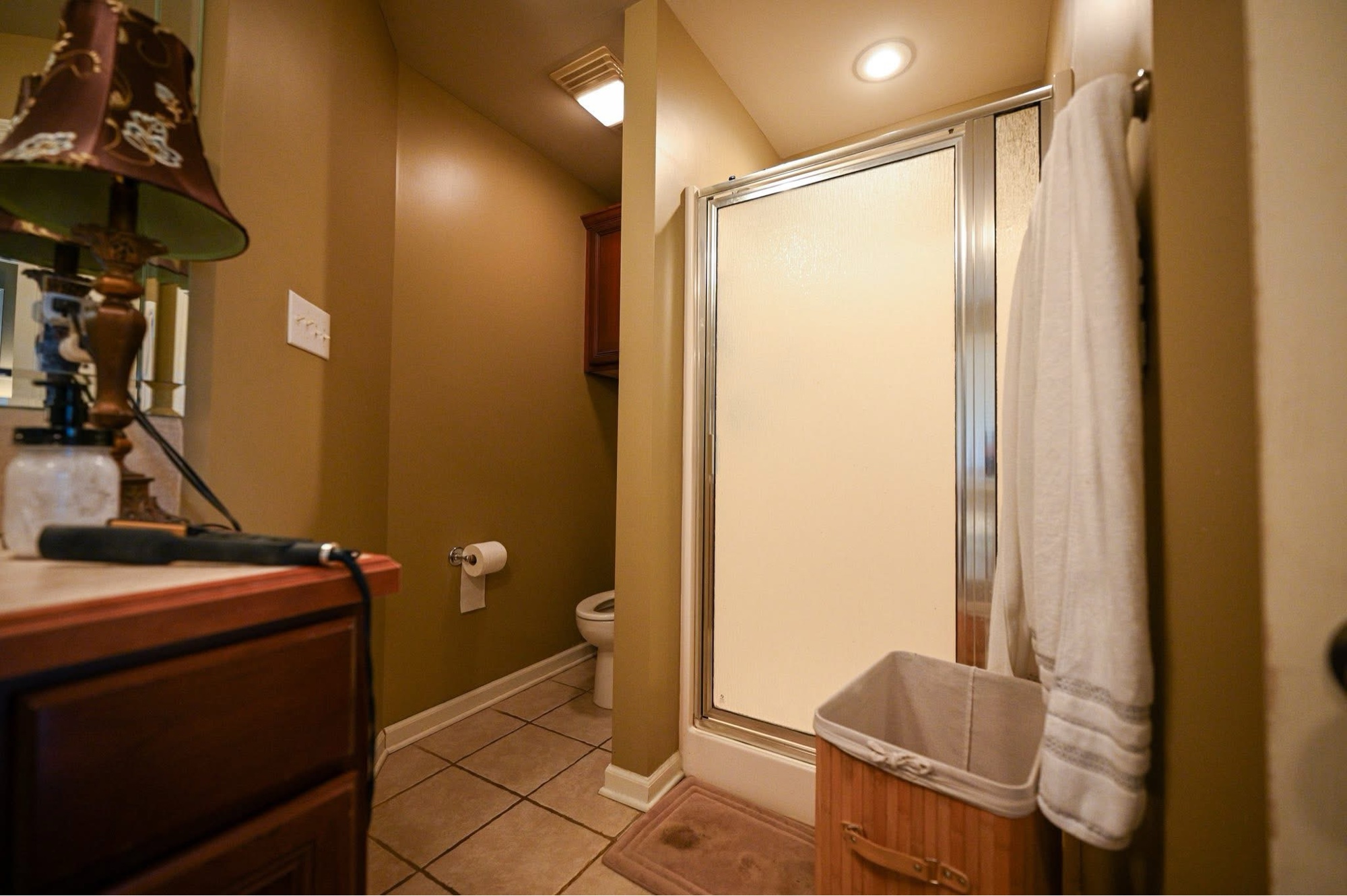 Guest bath before — mustard walls and cherry vanity