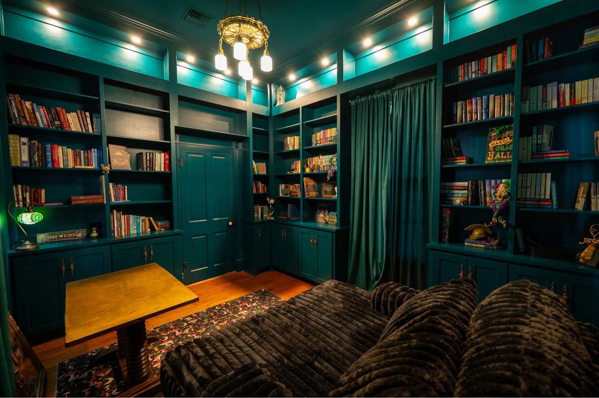 Hunter green library with chandelier